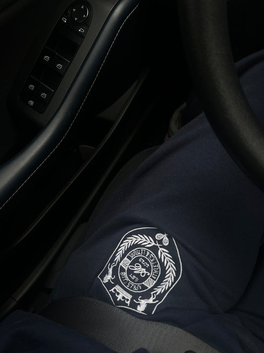 Navy Après Club crest fleece sweatpants, styled photo