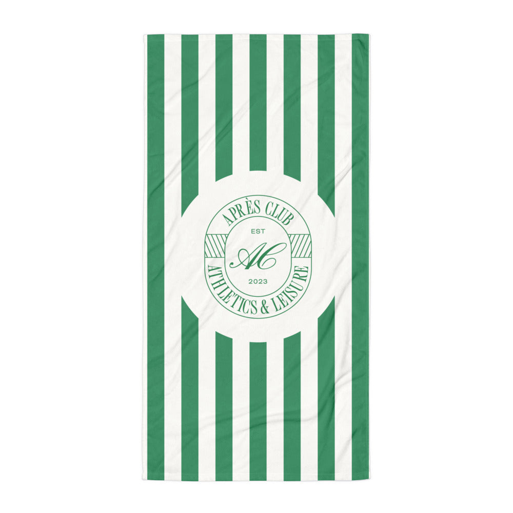Green and cream cabana stripe beach towel with Après Club badge at the centre