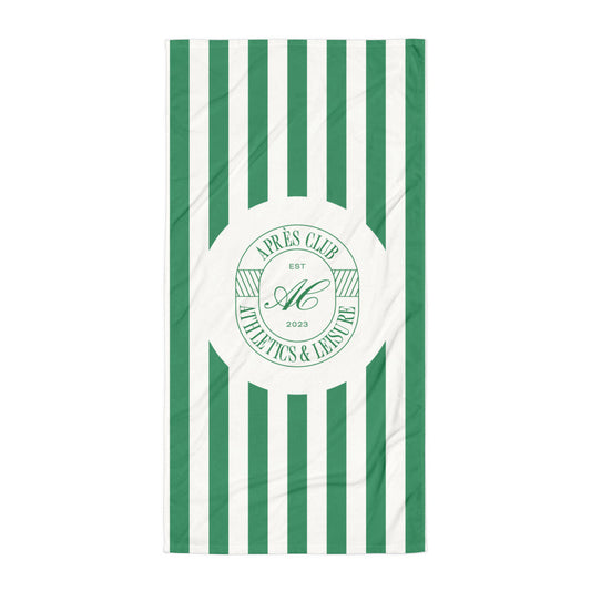 Green and cream cabana stripe beach towel with Après Club badge at the centre