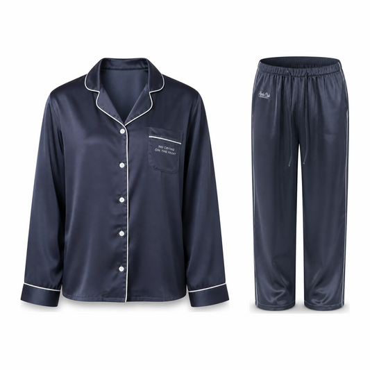 No Crying On The Yacht Pajama Set in navy satin, the top and pant laid flat side by side with white piping