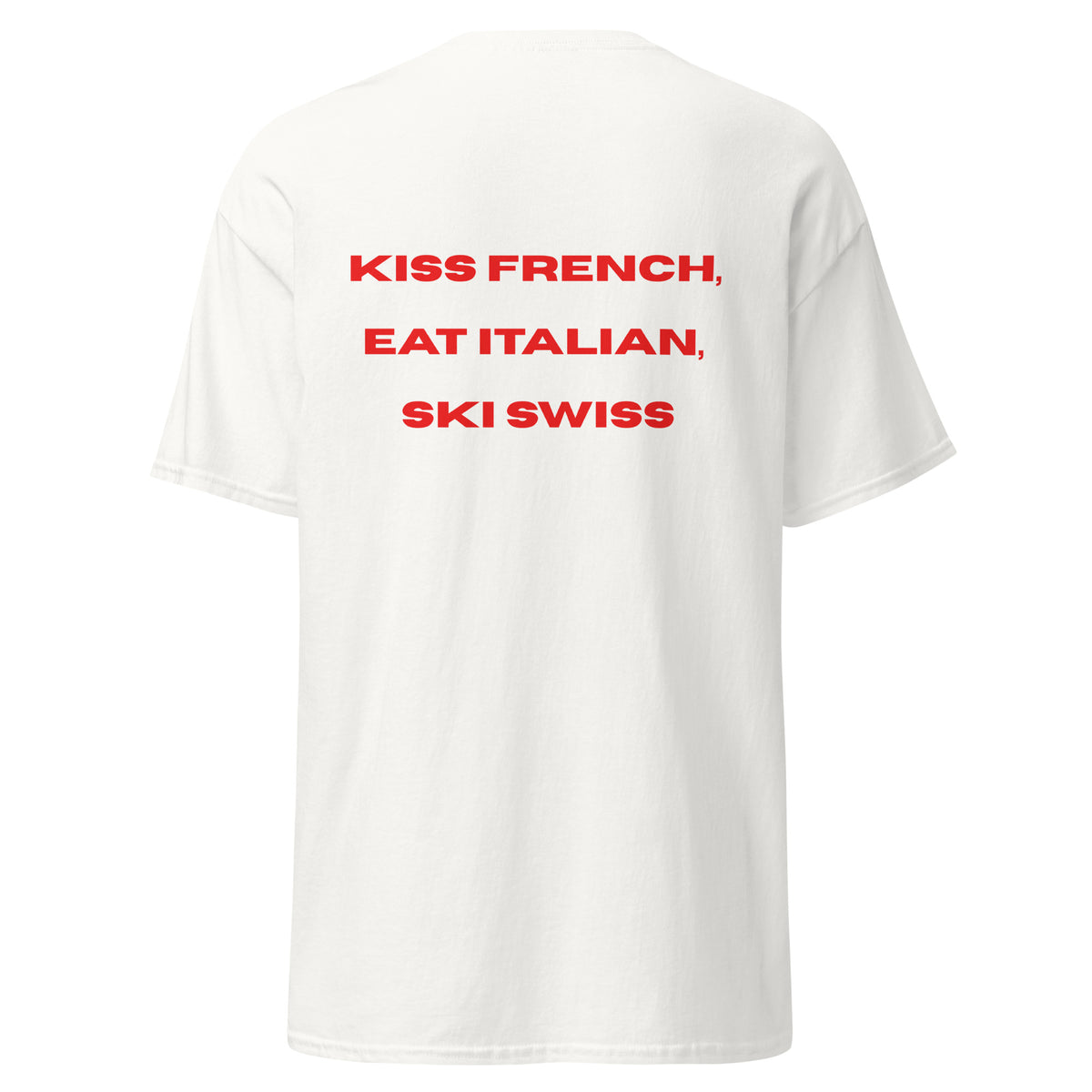 Red graphic text reading Kiss French, Eat Italian, Ski Swiss on the back of a white unisex t-shirt