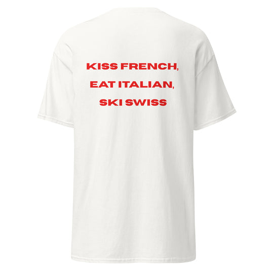 Red graphic text reading Kiss French, Eat Italian, Ski Swiss on the back of a white unisex t-shirt